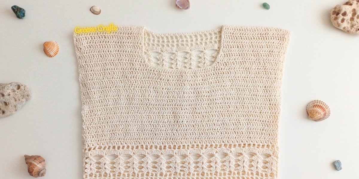 Close-up of the Summer Breeze crochet top showing the solid bust panel and lace body